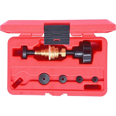 Werkzeugkoffer mit Spezialwerkzeug, rot, geöffnet. Enthält Schrauben, eine Spindel und verschiedene runde, gezahnte Teile.